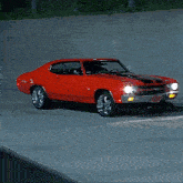 a red car with a license plate that says ' chevrolet ' on it