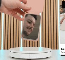 a person is holding a phone in a pink case with a picture of a man behind it