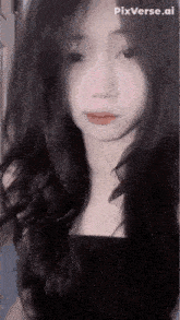 a close up of a woman 's face with long black hair and a black top .