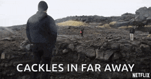 a man is standing on top of a rocky hill with the words `` cackle in far away '' written above him .