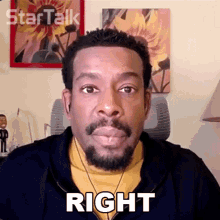 a man with a beard is wearing ear buds and has the word right on his face