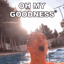 a man is swimming in a pool with the words oh my goodness above his head