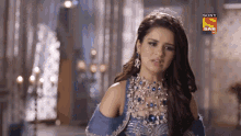 a woman wearing a blue dress and a tiara is on a sony sab hd screen