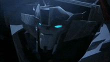 a close up of a robot 's face with blue eyes