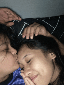a woman kissing another woman on the cheek
