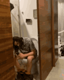 a woman sits on a toilet with her legs crossed