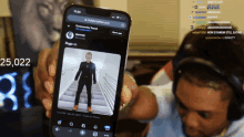 a person holding up a cell phone with a picture of a man on it