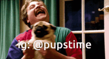 a man is laughing while holding a pug puppy with the hashtag @pupstime below him