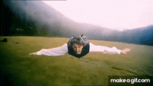 a person is flying through the air with their arms outstretched .