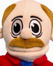 a stuffed man with a mustache and big eyes