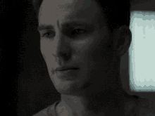 a close up of a man 's face in the dark