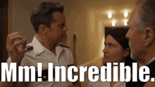 a man in a military uniform talks to a woman with the words mm ! incredible written above him