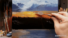 a painting is being painted with a spatula and the words made in animotica are on the bottom