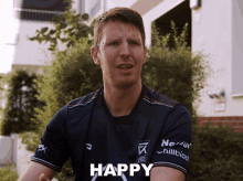a man in a blue shirt with the word happy on it