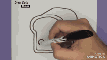 a person is drawing a slice of bread with a marker on a piece of paper