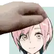 a close up of a person 's hand on a girl 's head .