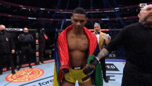 a man in a ufc shorts is standing on a stage