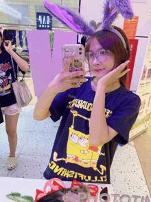 a girl wearing a spongebob t-shirt takes a selfie