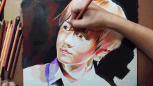a person is drawing a portrait of a young boy with colored pencils