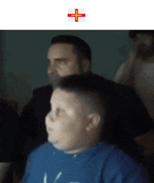 a blurry picture of a man and a boy with a cross on the bottom