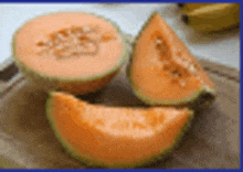 three slices of cantaloupe are sitting on a cutting board .