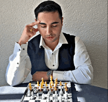 a man is playing a game of chess with his eyes closed