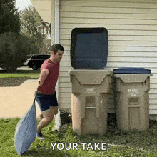 a man is carrying a garbage bag in front of a garbage can that says your take