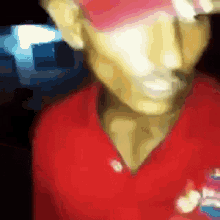 a blurry picture of a man in a red shirt