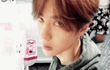 a close up of a young man 's face with a blurred background looking at something .