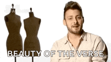a man is standing in front of two mannequins with the words `` beauty of the verse '' written above him .