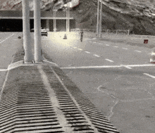 a car is driving down a highway with a tunnel in the background .
