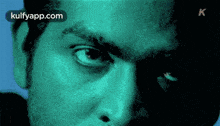 a close up of a man 's face with the website kulfyapp.com written on the bottom