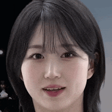 a close up of a young woman 's face with a fringe .