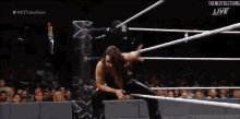 a woman is wrestling another woman in a ring .