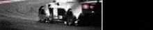 a black and white photo of a row of trucks driving down a road .