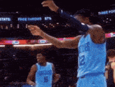 a basketball player in a blue jersey with the number 12 on the back