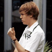 a young man wearing a white shirt with the word atlas on the front