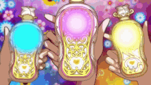 three bottles of perfume are being held by a person with flowers in the background