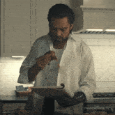 a man in a white shirt is holding a plate of food with thunderbolts written on the bottom