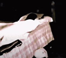 a person is laying in a bed with a white blanket on it