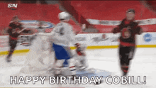 a hockey game is being played and the goalie is making a save .