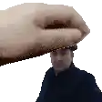 a hand is holding a man 's head in a pixel art style .