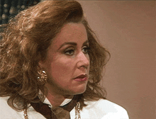 a close up of a woman wearing a white shirt and a tie