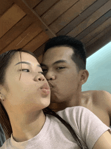 a man kisses a woman on the cheek
