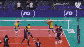 a volleyball game is being played in front of a banner that says ljubljana