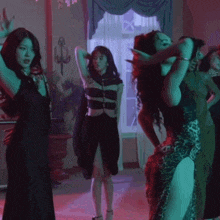 a group of women are dancing in a room with a window