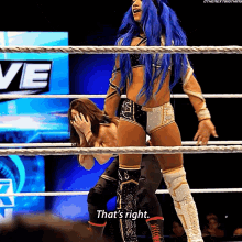 a woman with blue hair is standing in a wrestling ring and saying that 's right