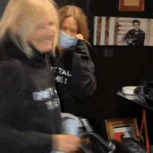 a woman wearing a black sweatshirt that says i 'm tall me