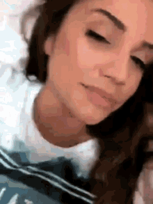 a close up of a woman 's face with her eyes closed and her mouth open .