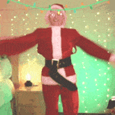 a man in a santa claus costume is dancing